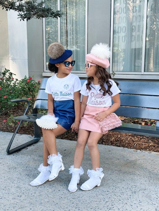 Pink vegan leather skirt styled for girls, showcasing an adjustable waist, clean hemline, and smooth faux leather material