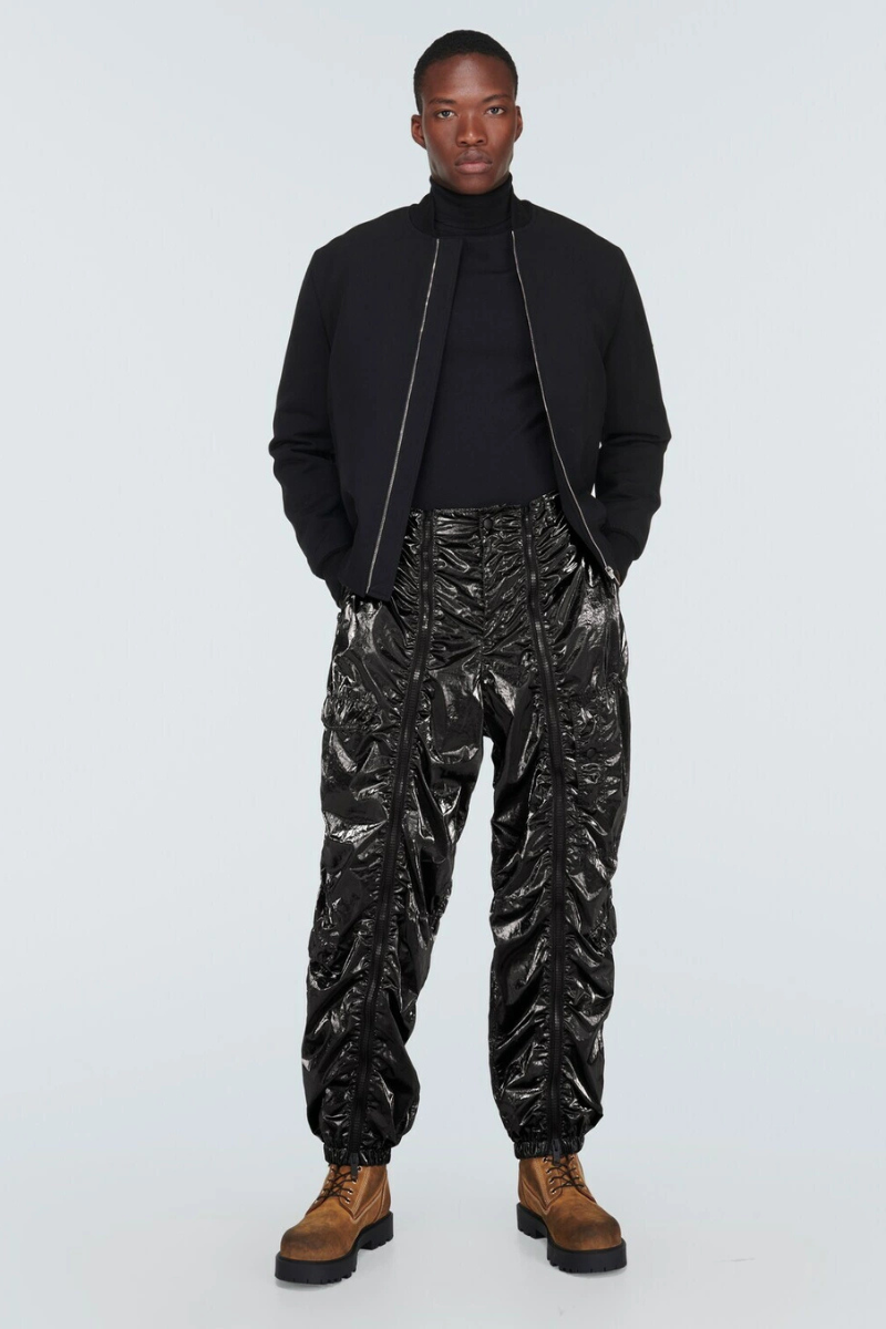 Givenchy Technical Cargo Pants displayed on a model wearing a black outfit and stylish boots.