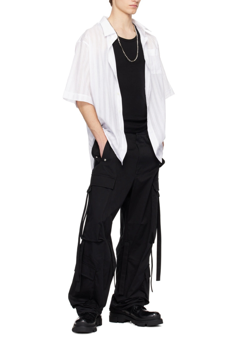 Givenchy Black Extended Trim Cargo Pants worn with a white striped shirt, featuring a relaxed fit and cargo pockets.