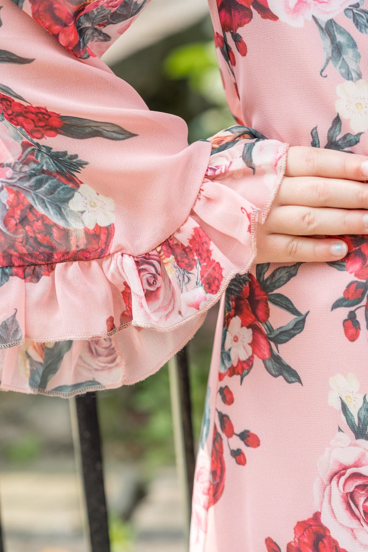 Close up of ruffled sleeve detail on Flora flower print jumpsuit in soft pink floral fabric