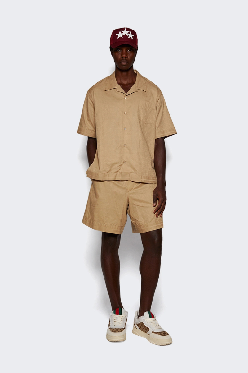 Givenchy Bowling Shirt Beige worn by model, featuring a Hawaiian collar and 4G pattern, paired with shorts.