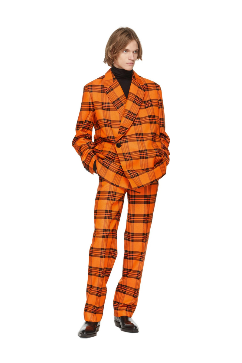 S.R. Studio. La. Ca. Orange & Black Plaid Straight Leg Trousers worn by a model, showcasing bold check patterns.