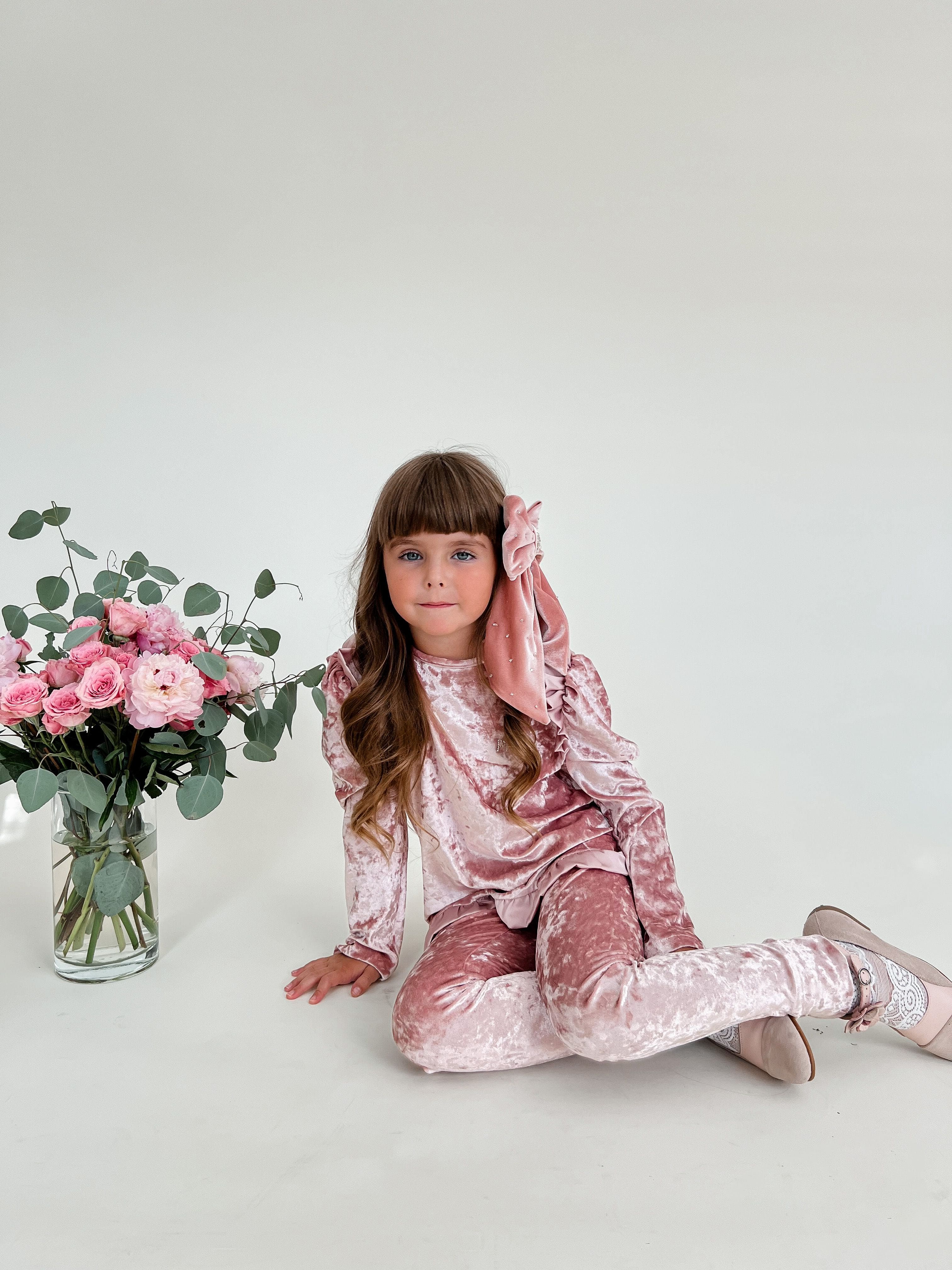 Pink velour lounge set styled for holiday and special occasions, soft velvet girls two piece outfit with ruffle trim
