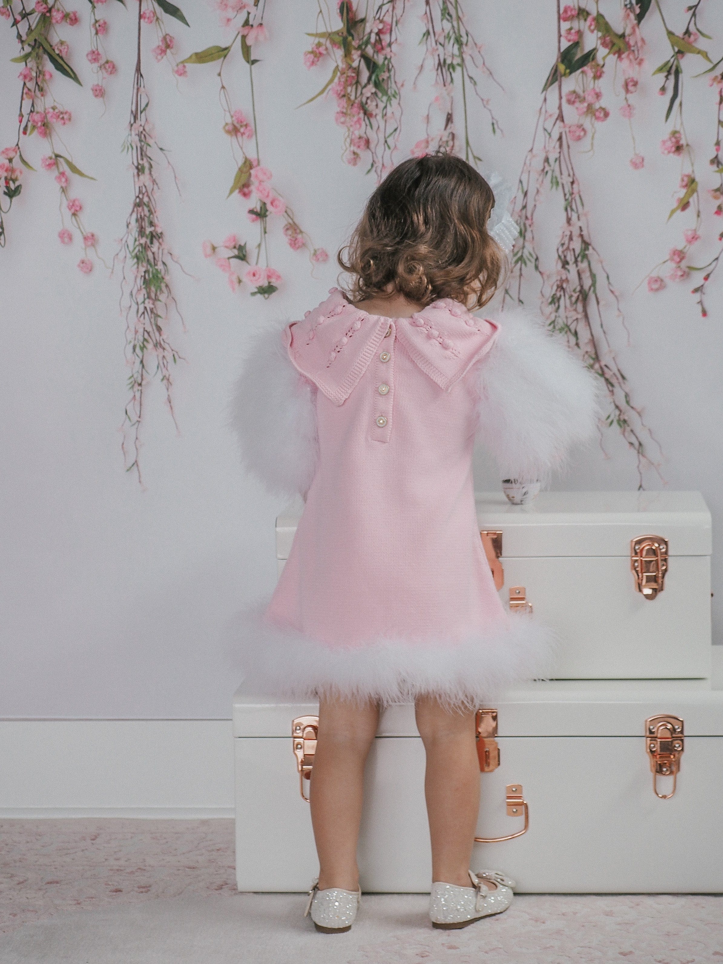 Back view of Ella Knit pink feather dress showing button clasp closure and fold-over embellished collar