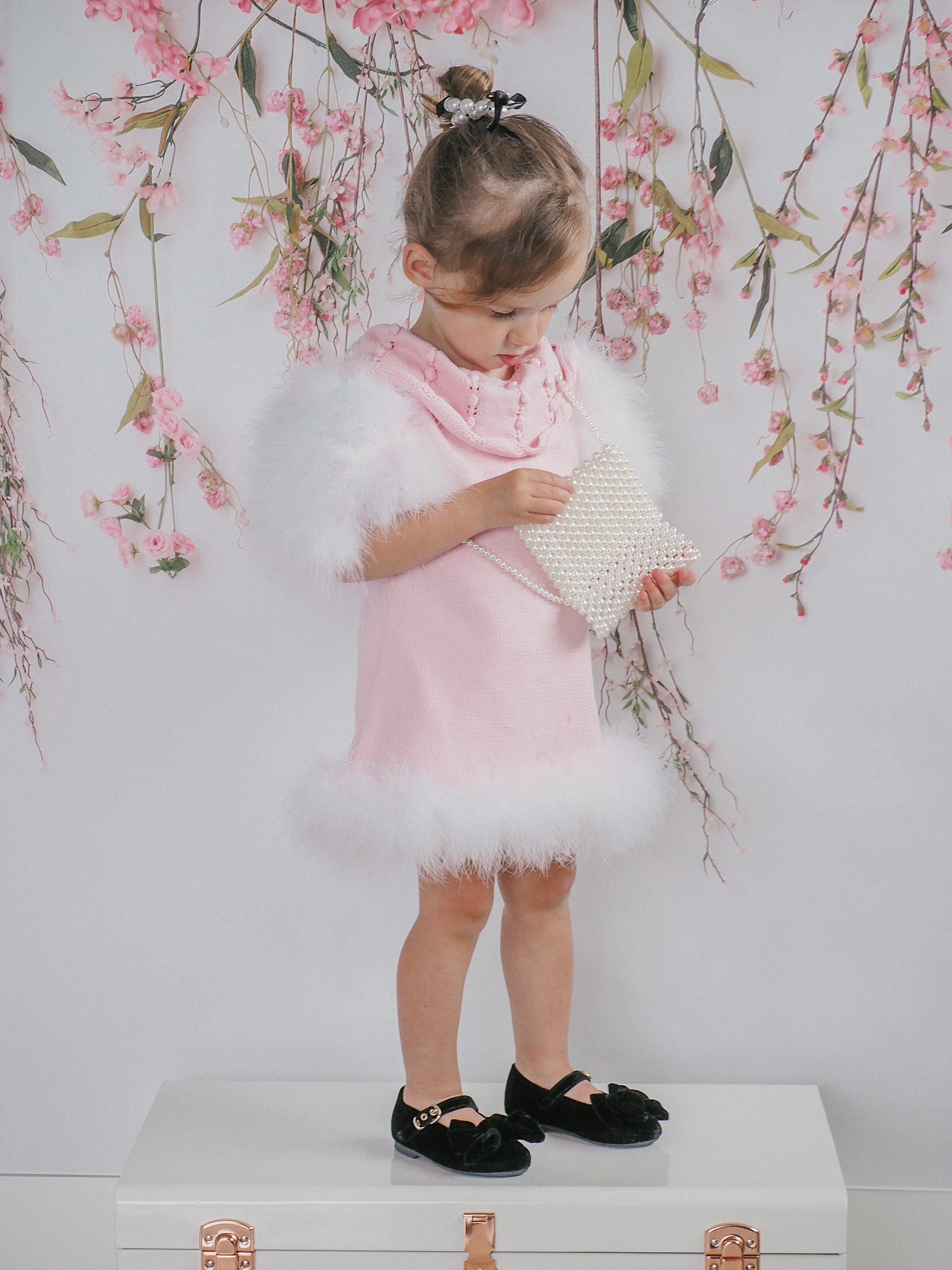 Front view of Ella Knit Pink Feather Dress modeled by young girl highlighting knit texture and neckline detail