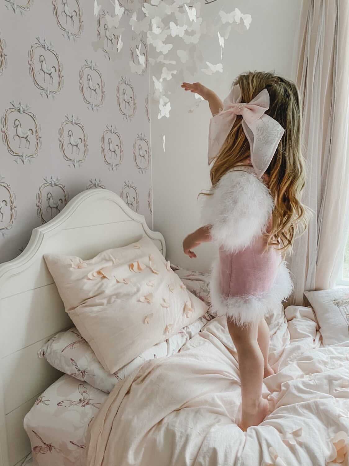 Side view of Ella Knit pink feather dress showing textured knit fabric and feather sleeve detail