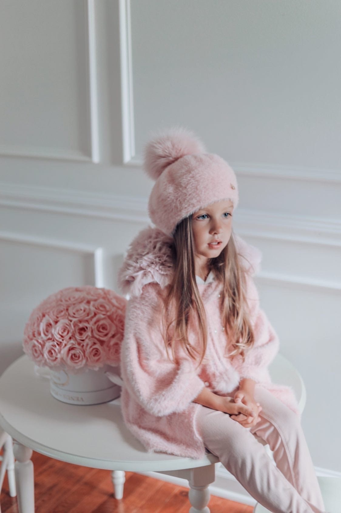 Girl wearing Milana Rose Beret in blush pink paired with faux fur coat for elegant cold weather look.