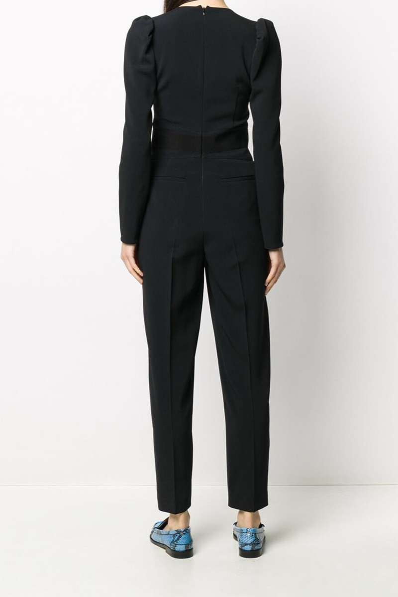 Back view of a woman wearing a RED Valentino Black Women‘s Jumpsuit with stylish blue shoes.