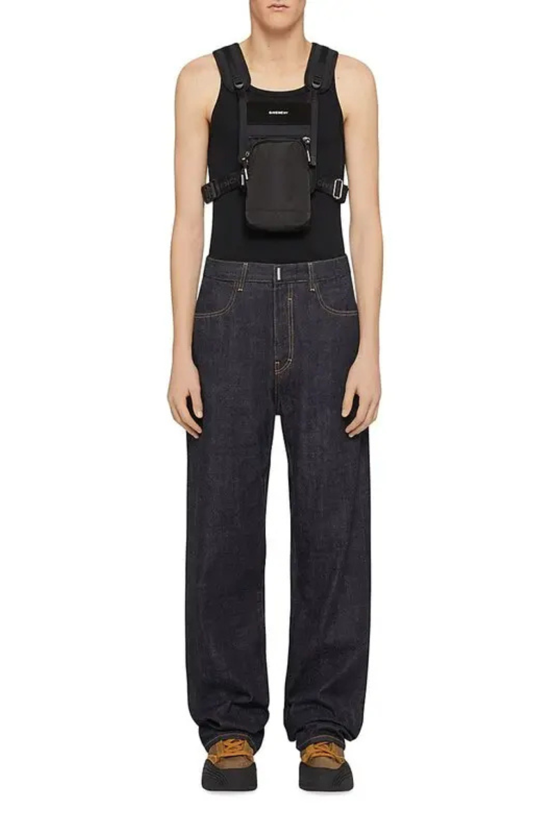 Givenchy Men's Jeans in Denim Indigo Blue worn with a black harness and casual shoes.