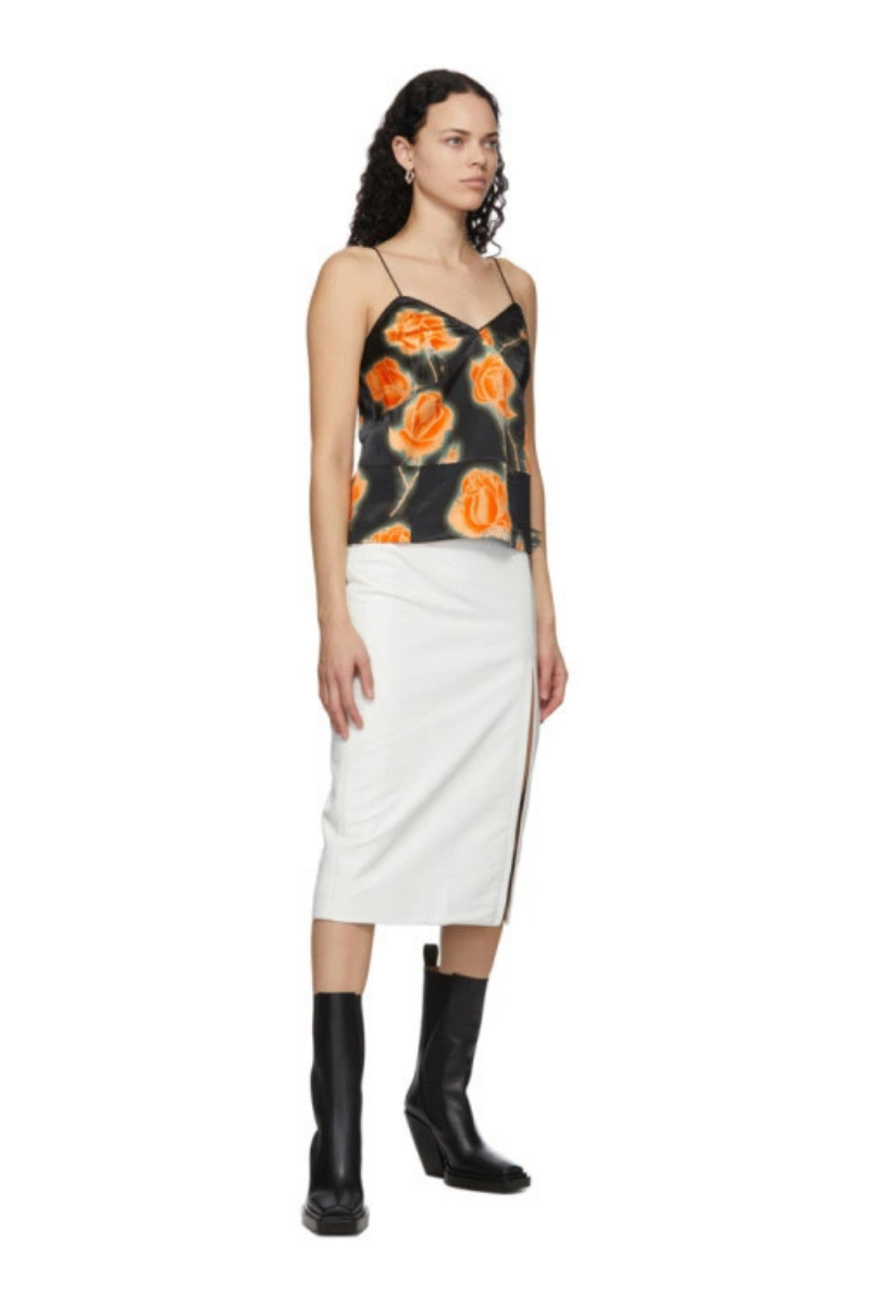 Meryll Rogge White Leather Vintage Slit Skirt worn with a floral top, showcasing a sleek silhouette and modern style.
