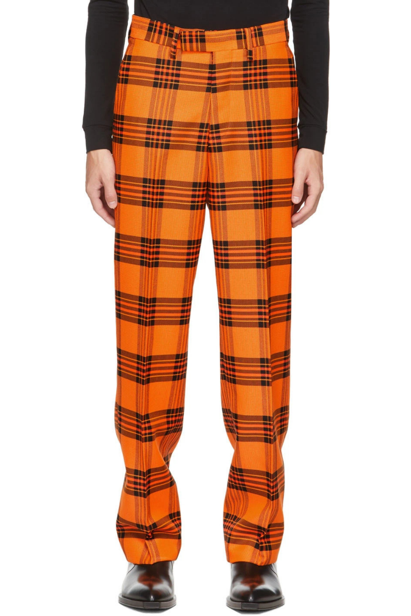 S.R. Studio. La. Ca. Orange & Black Plaid Straight Leg Trousers worn by a model, showcasing the vibrant check pattern.