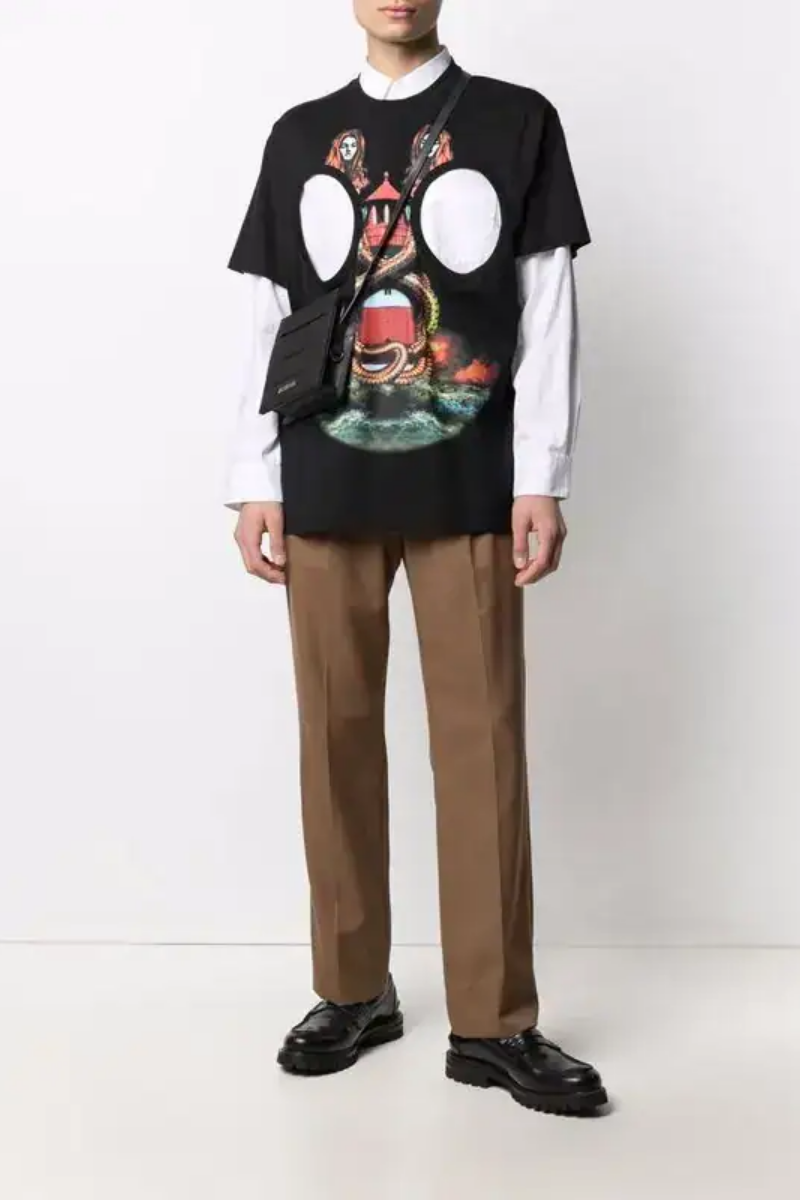 Burberry Mermaid-Print Cut-Out T-Shirt on a model wearing brown pants and a crossbody bag, showcasing the mermaid motif design.