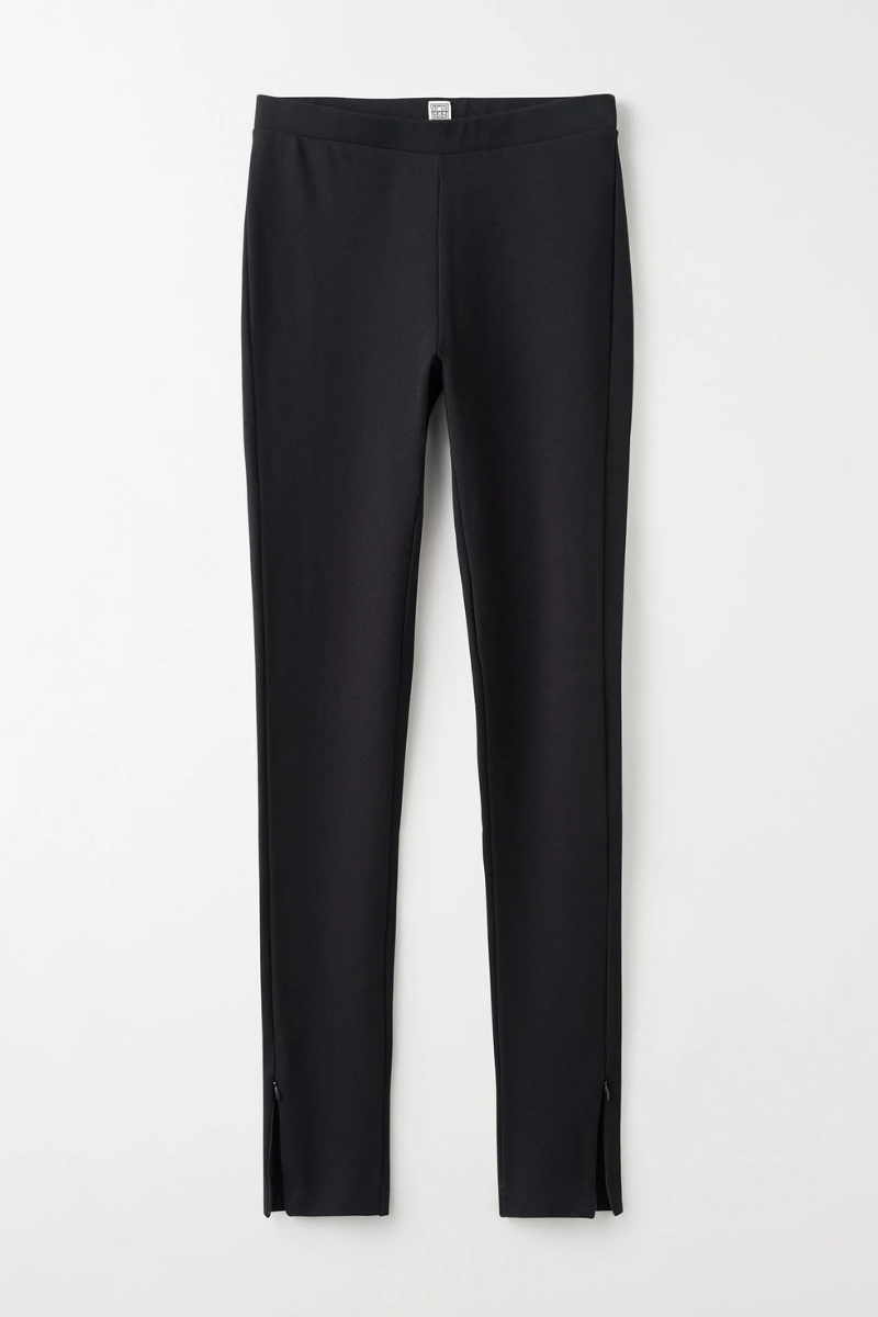 Toteme Zip Leggings in Black, featuring a sleek design with zip detail, made from a soft viscose blend.