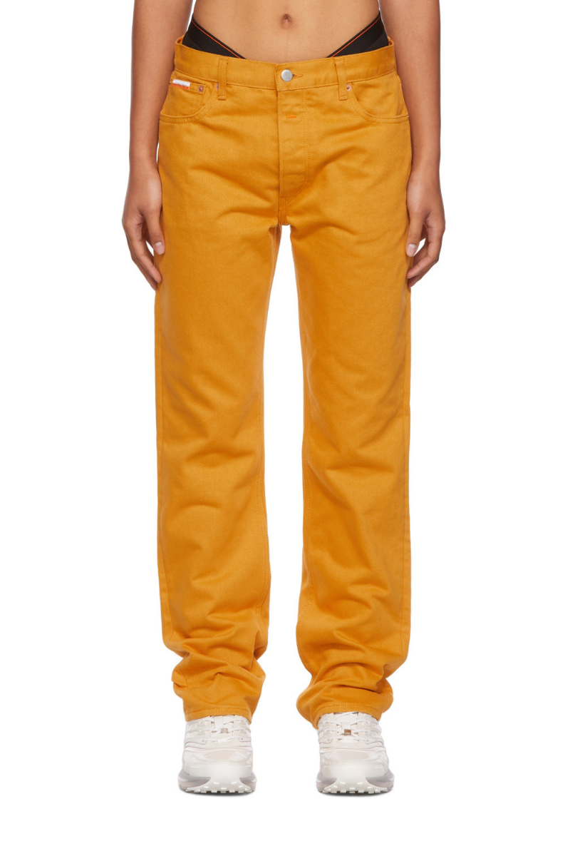 Calvin Klein Women's Casual Pants in Yellow displayed on a model, highlighting the vibrant yellow color and casual style.