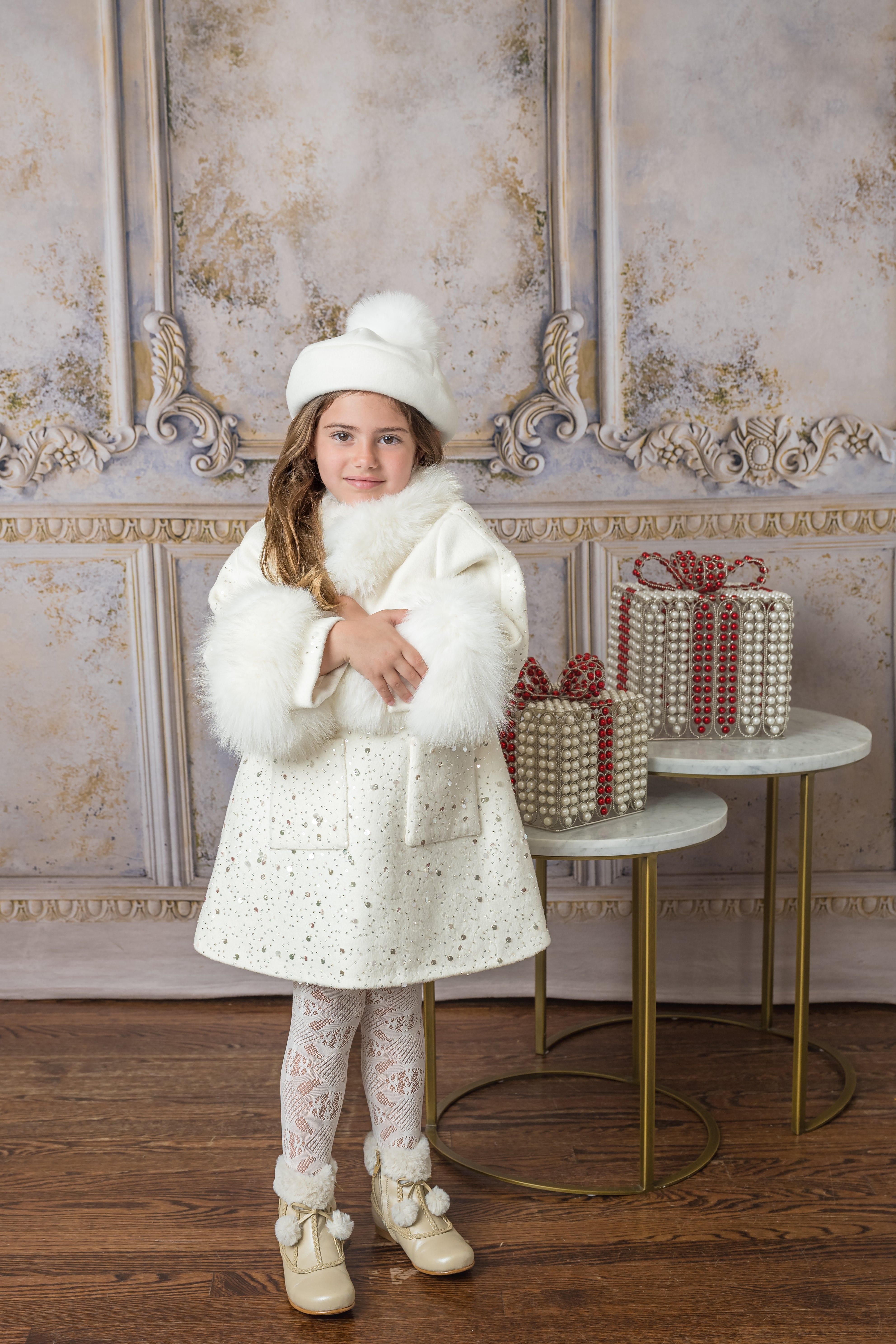 ivory marshmallow wool coat. perfect for the winter season detailed with fur and gems all around the coat 