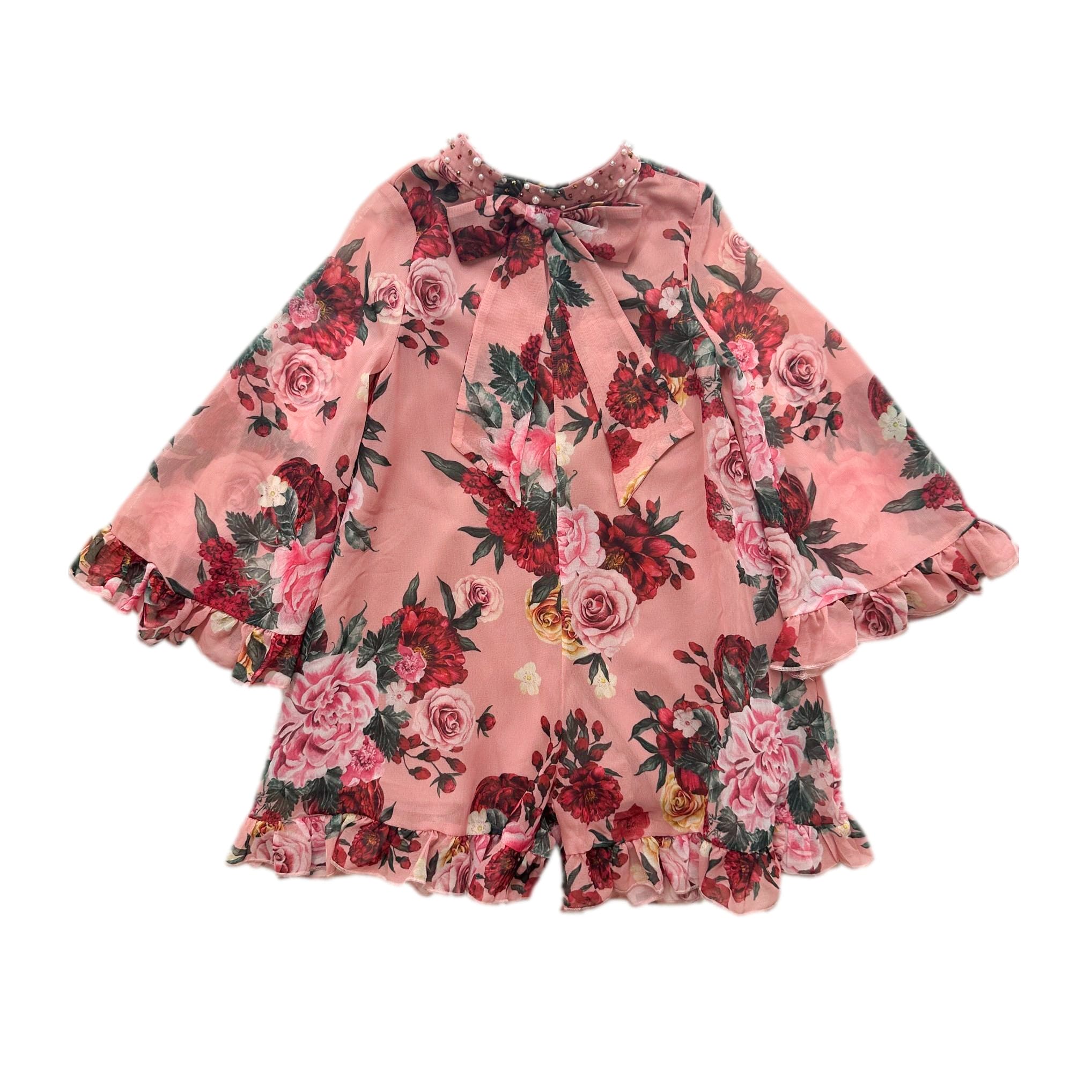 Flora pink floral print girls jumpsuit with criss cross back, hand beaded pearl neckline, pussycat bow detail, and shorts silhouette.