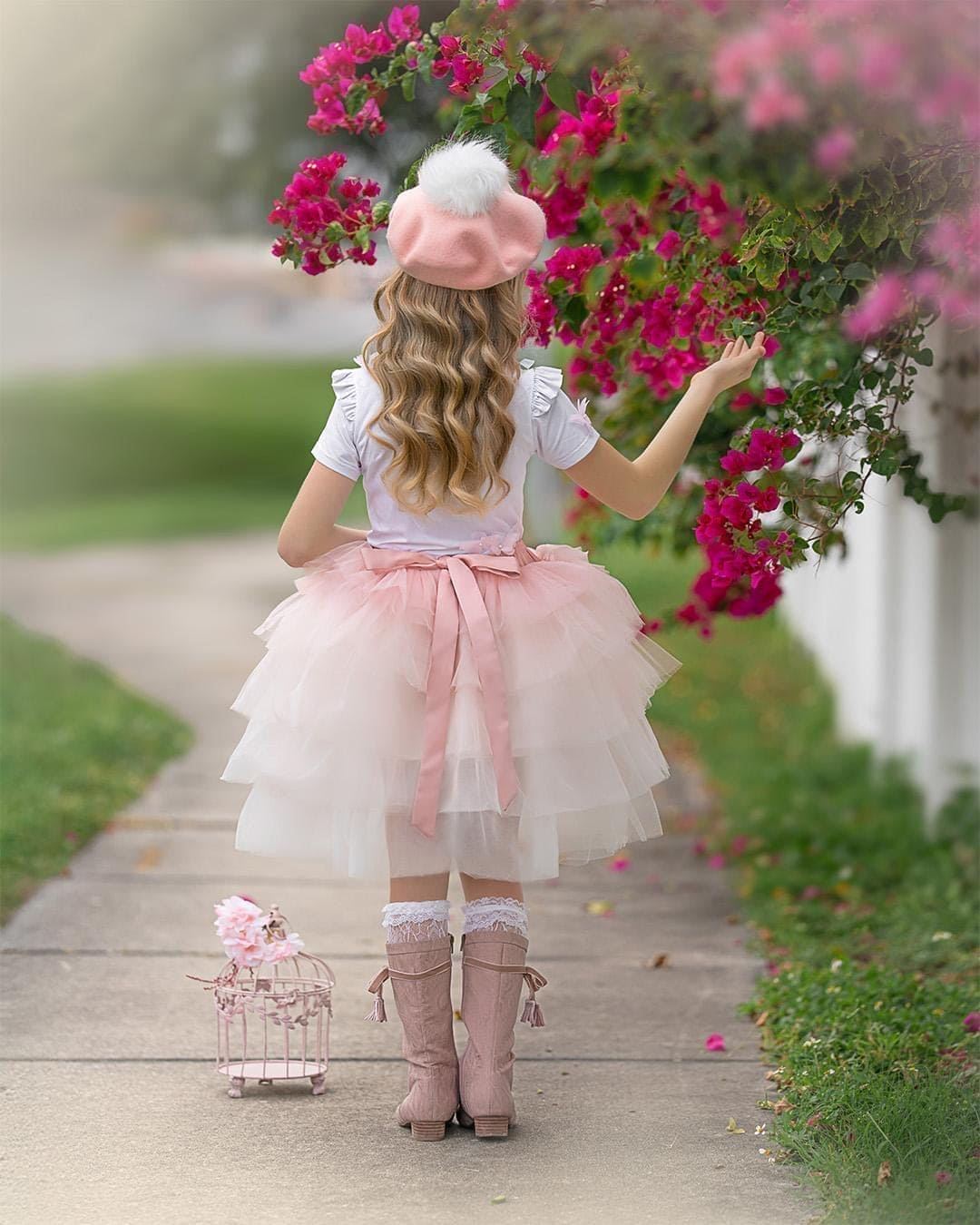 Back view of girls pink ombré tutu skirt with flowing satin ribbon bow and layered tulle in blush and ivory.