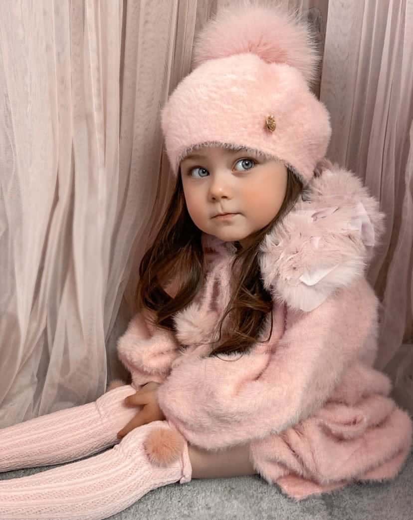 Toddler wearing Milana Rose Beret in blush pink with pom pom, soft winter baby accessory.