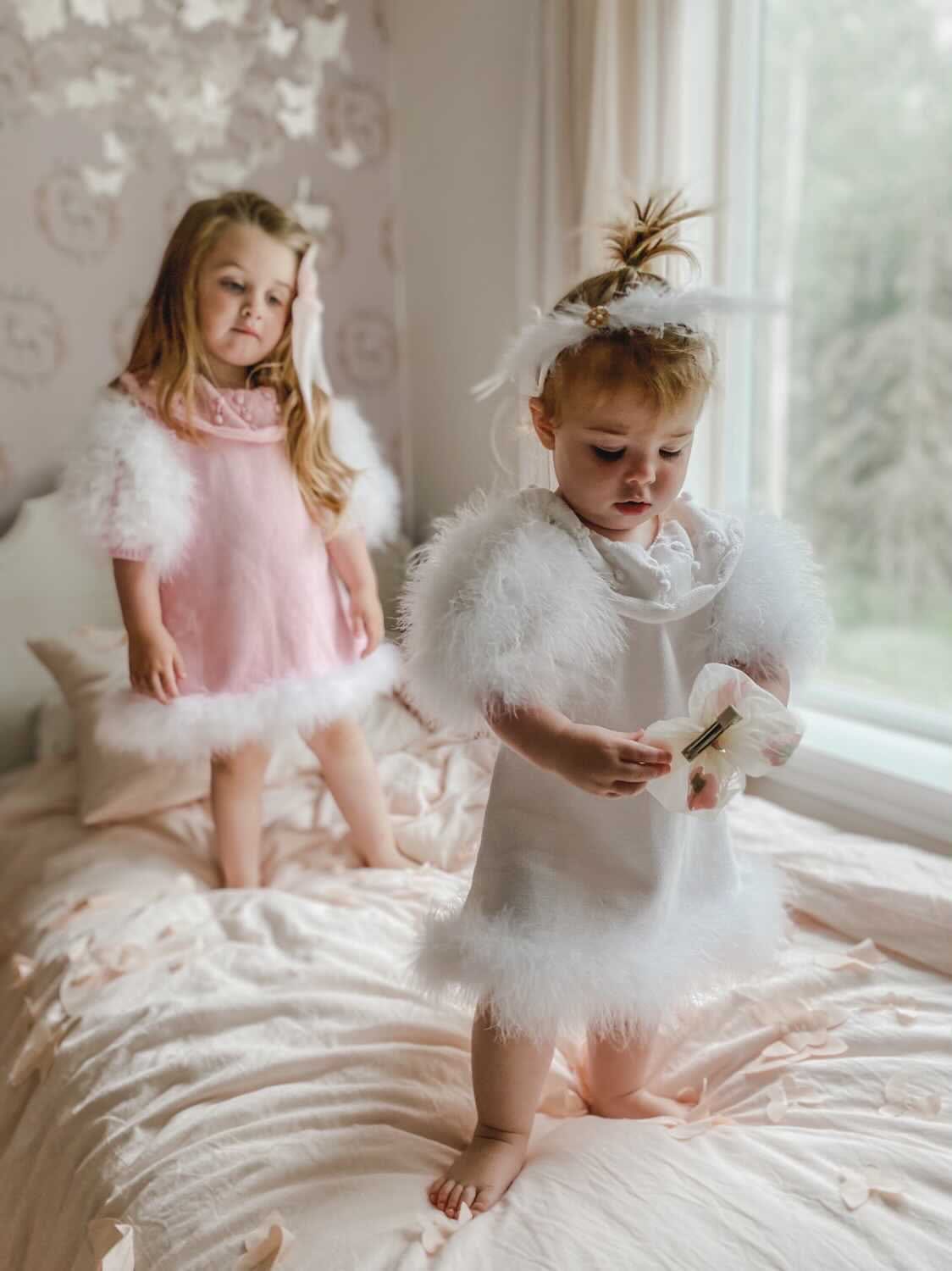 Child wearing Ella Knit pink party dress with statement collar and fur puff sleeves